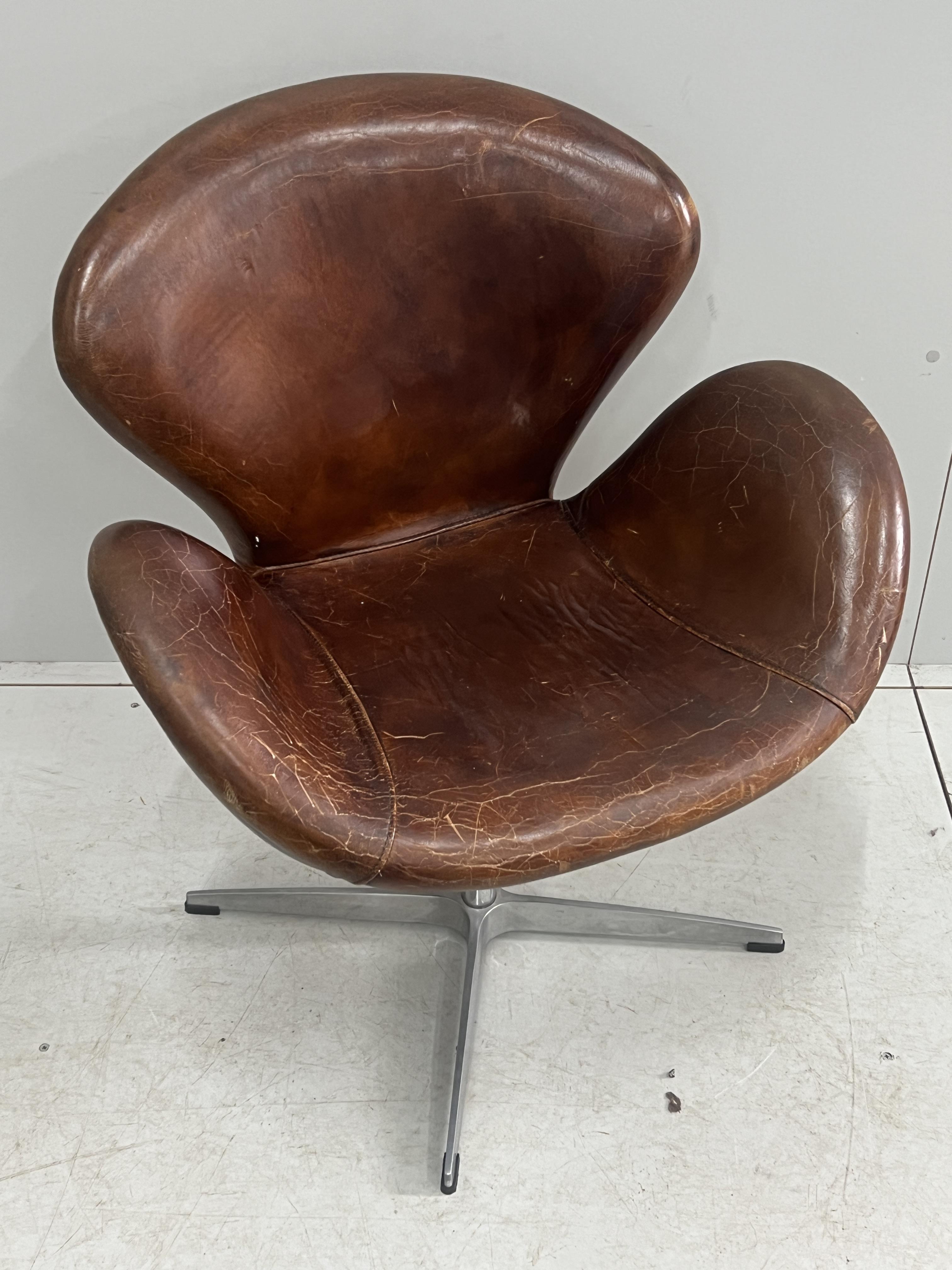 A tan leather petal chair, width 70cm, depth 42cm, height 84cm